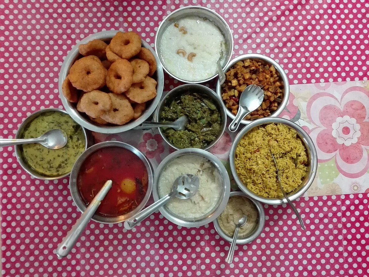 A spread of South Indian festival dishes including rice, curries, and traditional accompaniments