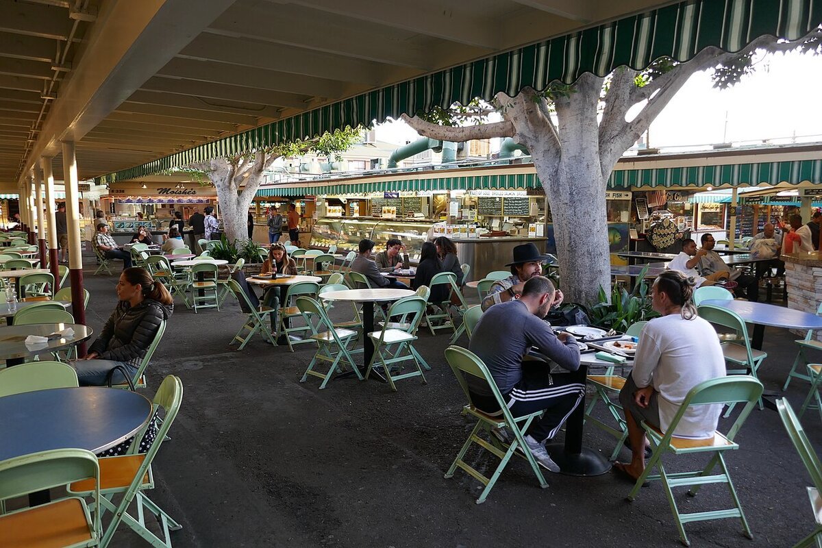Shaded outdoor seating under striped awnings at the Original Farmers Market in Los Angeles