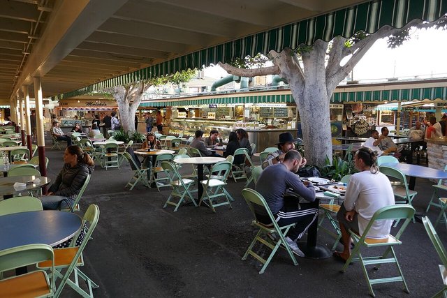 Shaded outdoor seating under striped awnings at the Original Farmers Market in Los Angeles