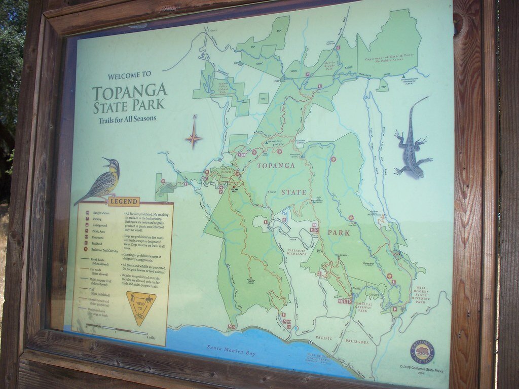 Trail map of Topanga State Park in a wooden frame, showing trails, ridgelines and the coast