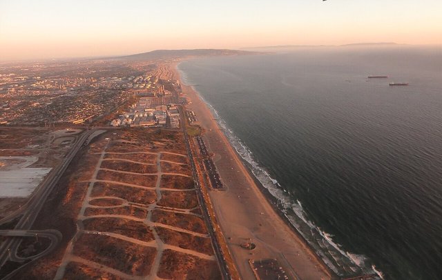 Aerial view of the El Segundo shoreline at sunset, with the beach, dunes and Pacific Ocean