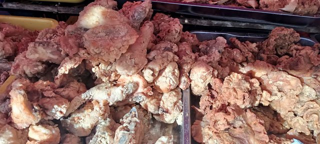 Crispy fried chicken pieces arranged on a plate, golden-brown with a crunchy coating