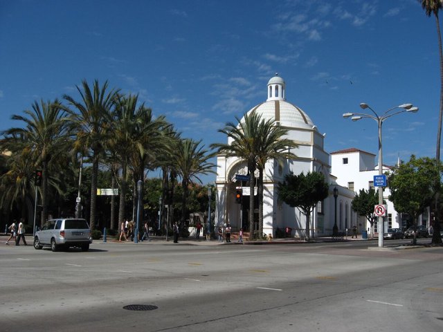 White domed building and palm trees at a Westwood Village intersection under a blue sky