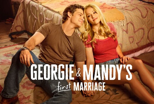 Promotional art for Georgie & Mandy's First Marriage showing the two leads seated on a rug beside a bed