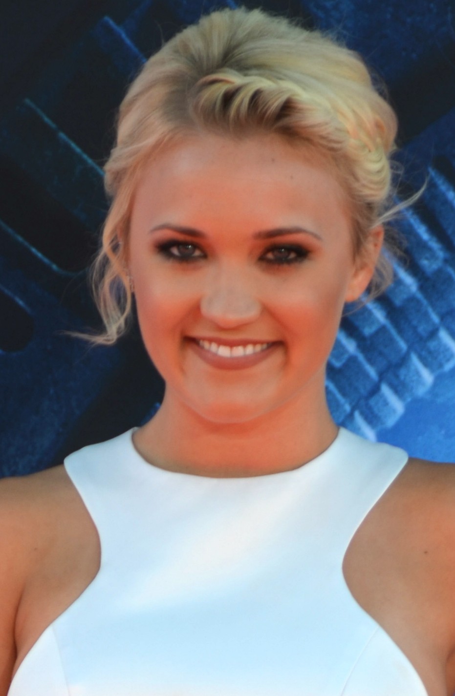 Emily Osment, who plays Mandy, smiling at a red carpet event