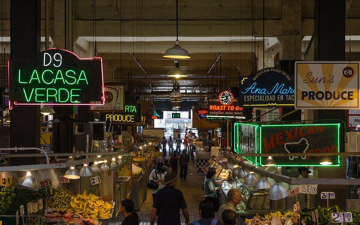 Neon signs and shoppers inside Grand Central Market in downtown Los Angeles