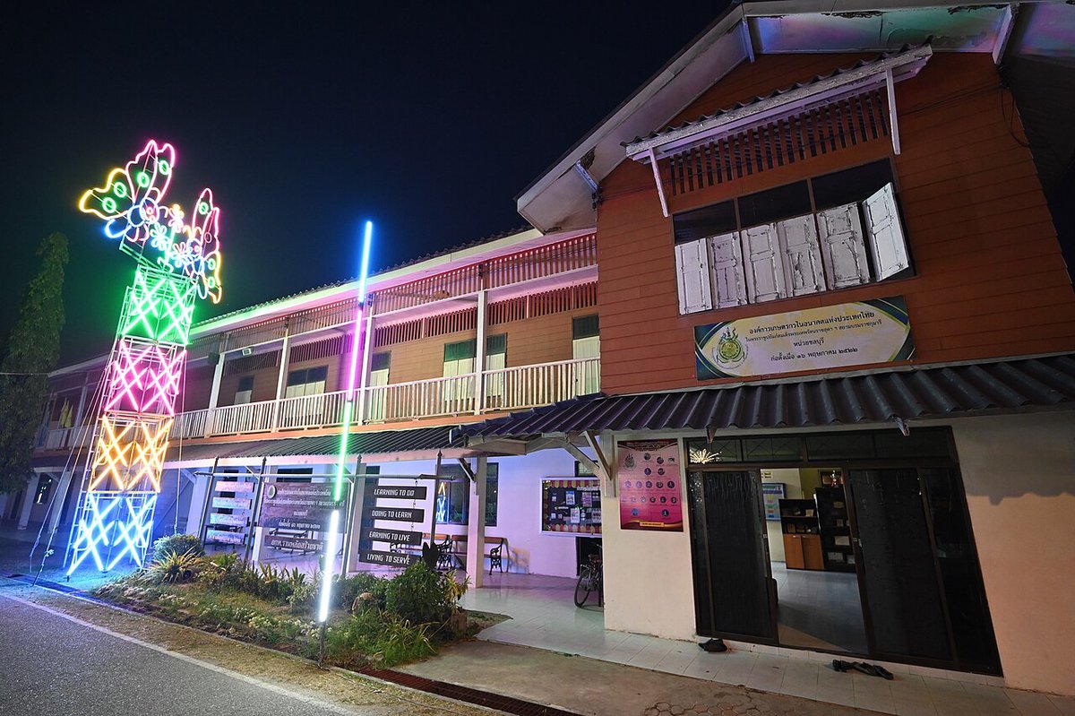 A two-story building at night decorated with colorful neon lights