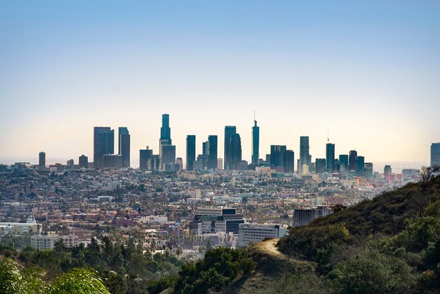 Downtown Los Angeles skyline seen from a dirt trail on the hills of Griffith Park