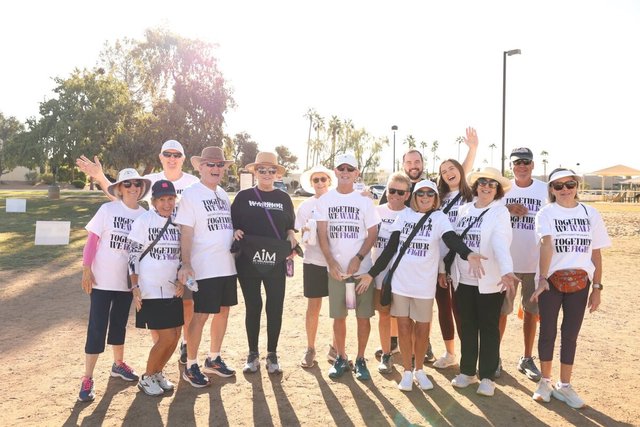 Group of walkers in matching Together We Walk, Together We Fight shirts at a past Steps Against Melanoma walk