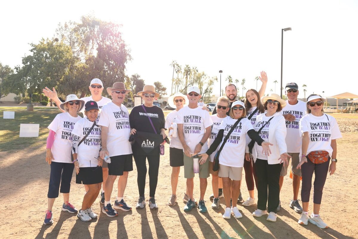 Group of walkers in matching Together We Walk, Together We Fight shirts at a past Steps Against Melanoma walk