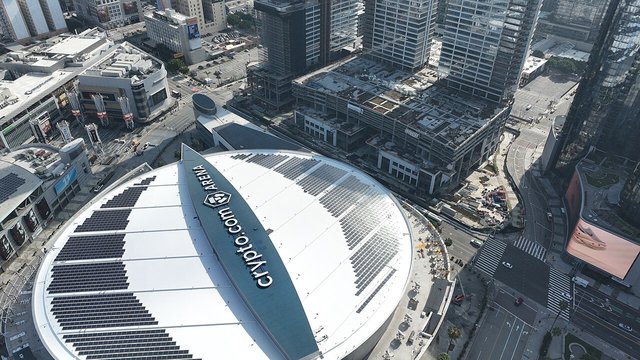 Aerial drone view of Crypto.com Arena and the surrounding downtown Los Angeles skyline at dusk