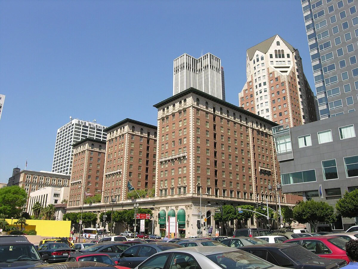 The Millennium Biltmore Hotel in downtown Los Angeles, a tall brick building with a low base seen from across a parking lot