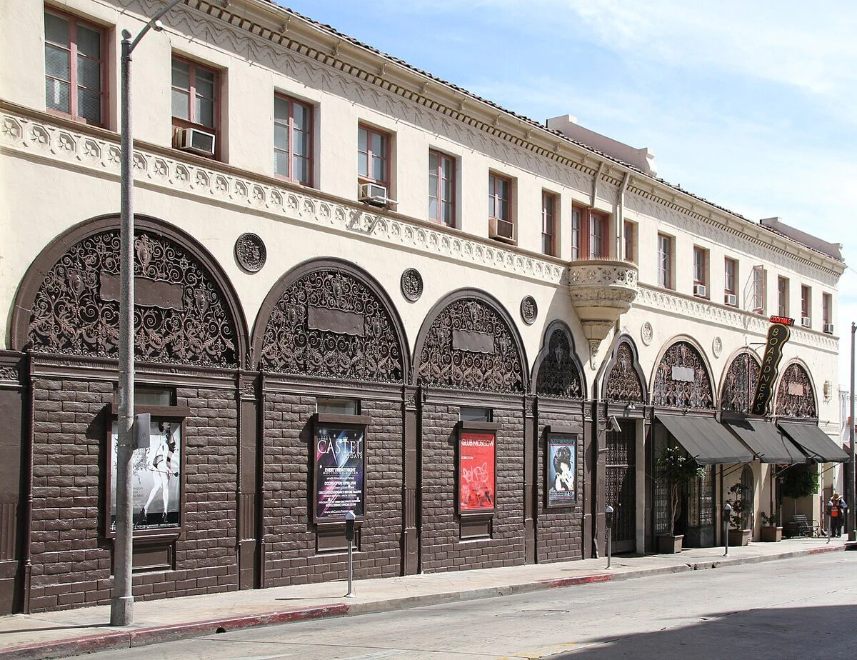 The arched ironwork facade of the Cherokee Building on North Cherokee Avenue, with the Boardner's cocktails sign hanging over the entrance