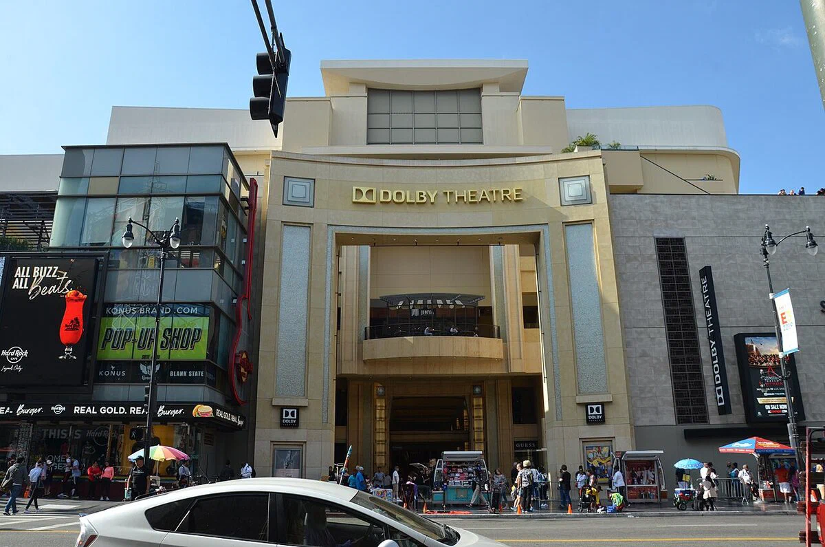 The Dolby Theatre's cream-colored arched entrance on Hollywood Boulevard with the Dolby Theatre name above it in daylight