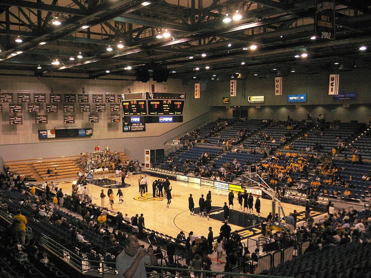 The Bren Events Center's basketball court and two-level seating bowl under the lights before a UC Irvine game