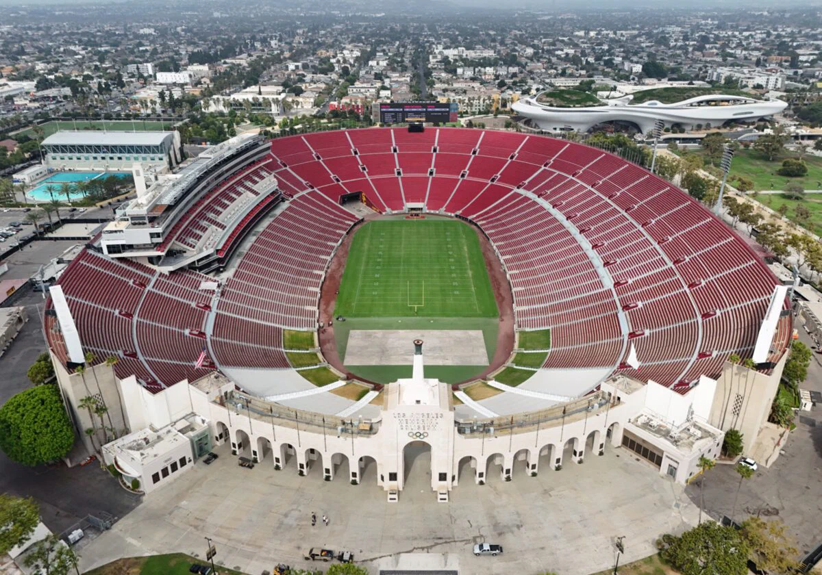 Aerial view of the Los Angeles Memorial Coliseum's red seating bowl and its peristyle arches in Exposition Park