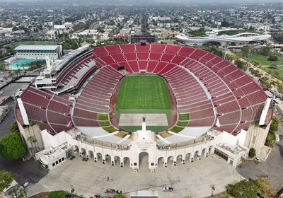Aerial view of the Los Angeles Memorial Coliseum's red seating bowl and its peristyle arches in Exposition Park