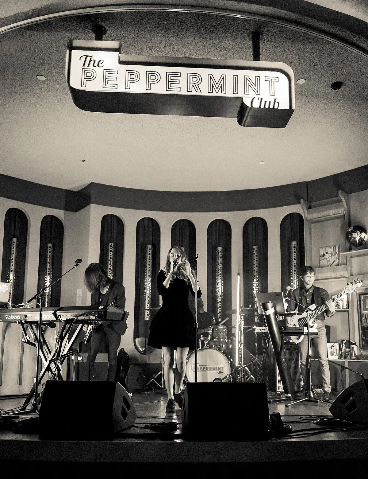 The stage at The Peppermint Club under the club's sign during a show