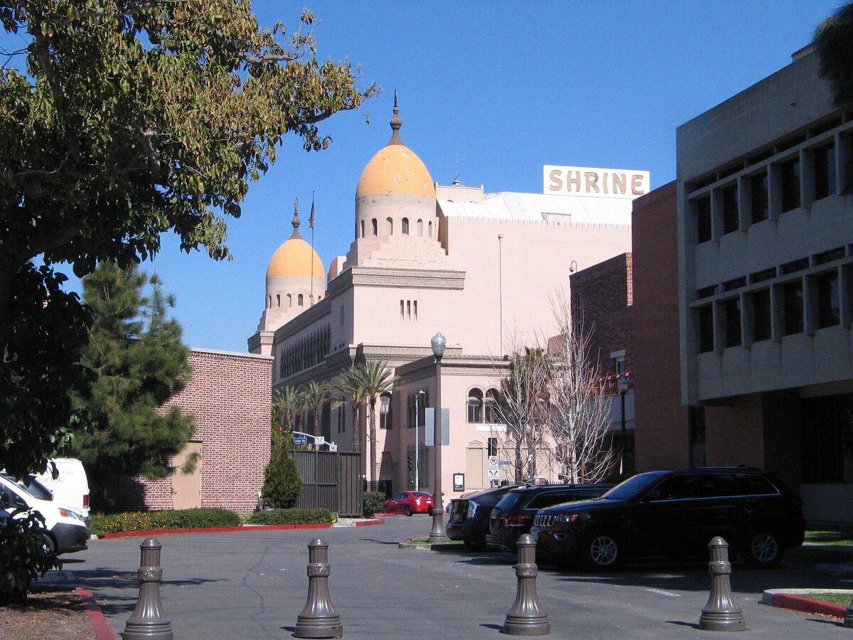 Golden domes of the Shrine Auditorium and its rooftop SHRINE sign, the building beside Shrine Expo Hall