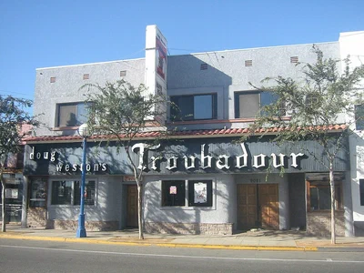 The Troubadour's white two-story front on Santa Monica Boulevard with Troubadour in Gothic letters across the awning